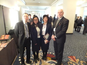 Four researchers in hotel ballroom area